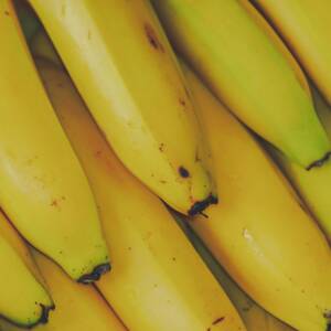 Vibrant and fresh close-up of yellow bananas, highlighting their ripe texture and appeal.